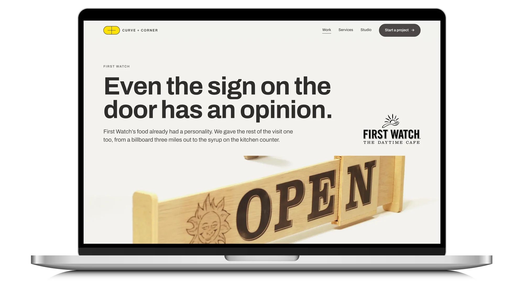 A laptop showing the First Watch case study, with the Open and Nope door sign, on the Curve + Corner site