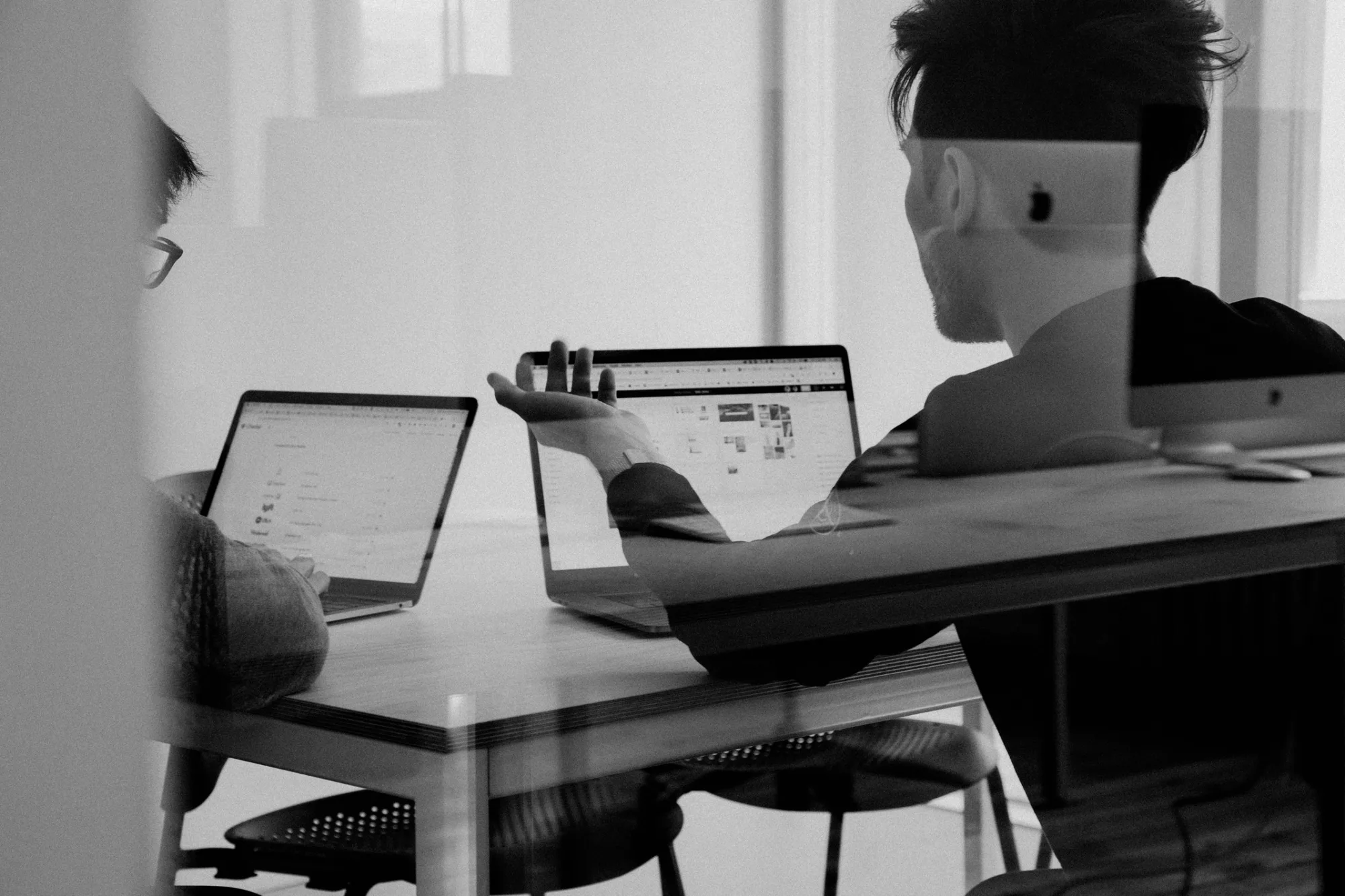Two people working through a design together at a shared table
