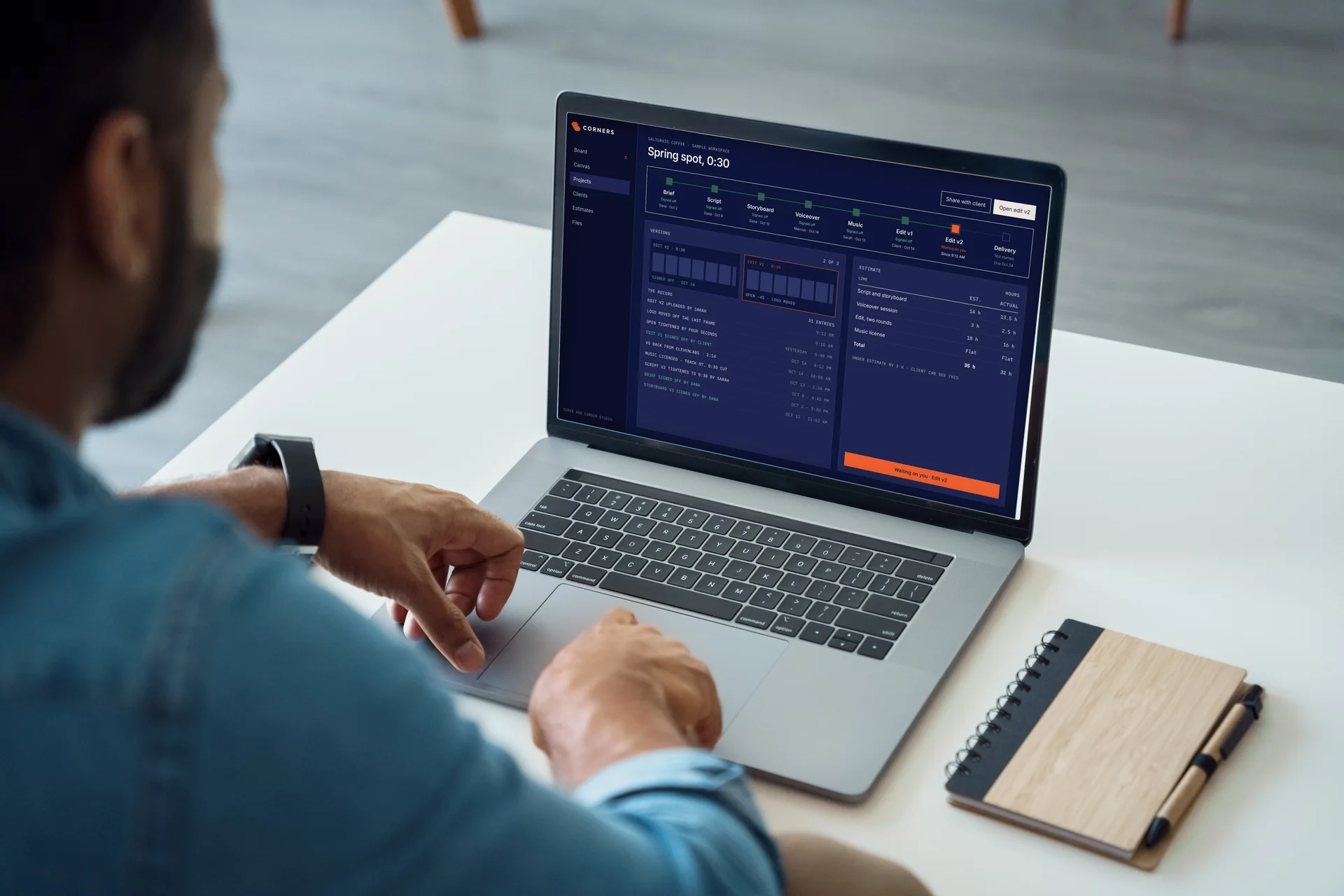 A Corners project record on a laptop: one spot from brief to delivery, every step signed off with a name and a date, and the estimate in hours beside it