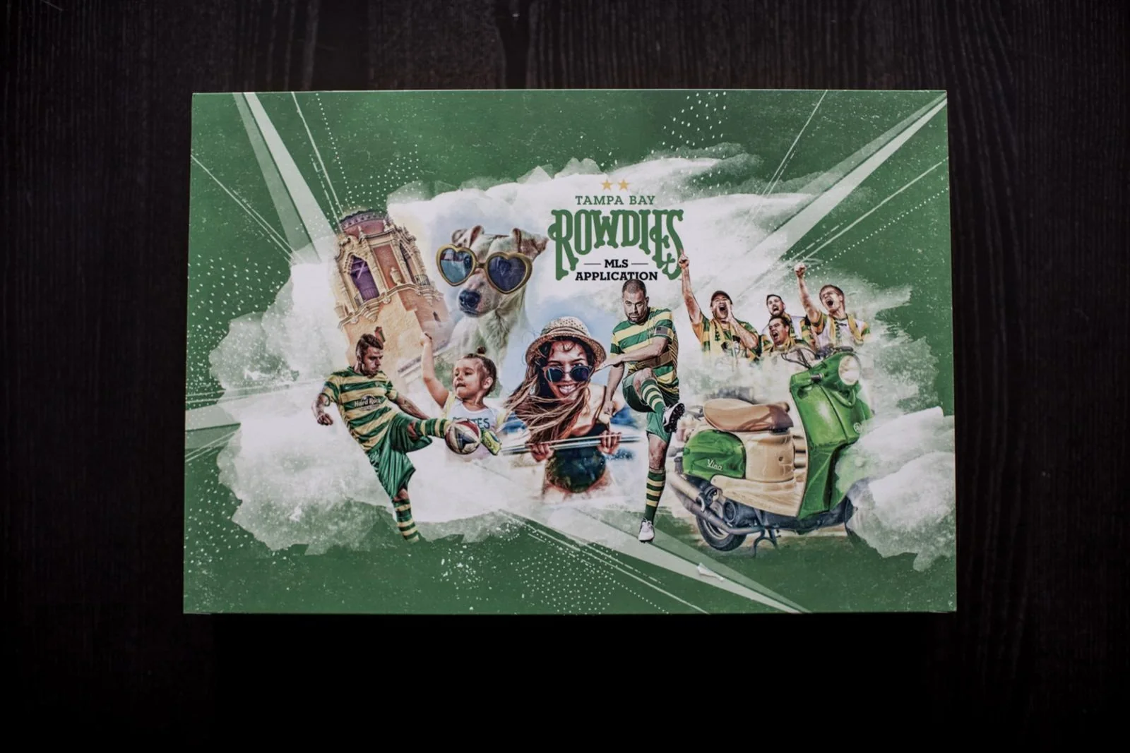 The Tampa Bay Rowdies MLS application book: fans, players and a green Vespa bursting out of the cover