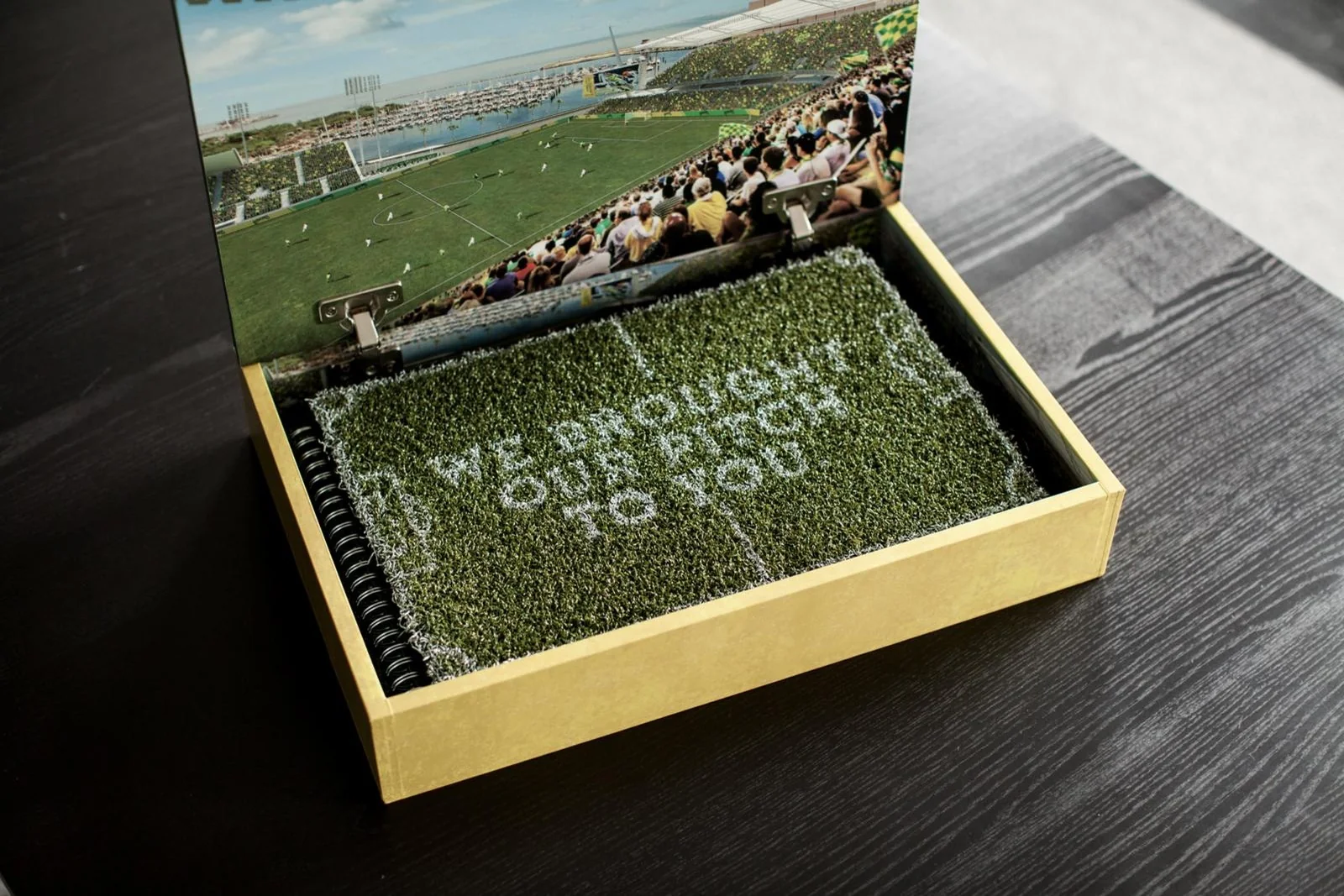 A pop-up stadium rises from the lid of the box